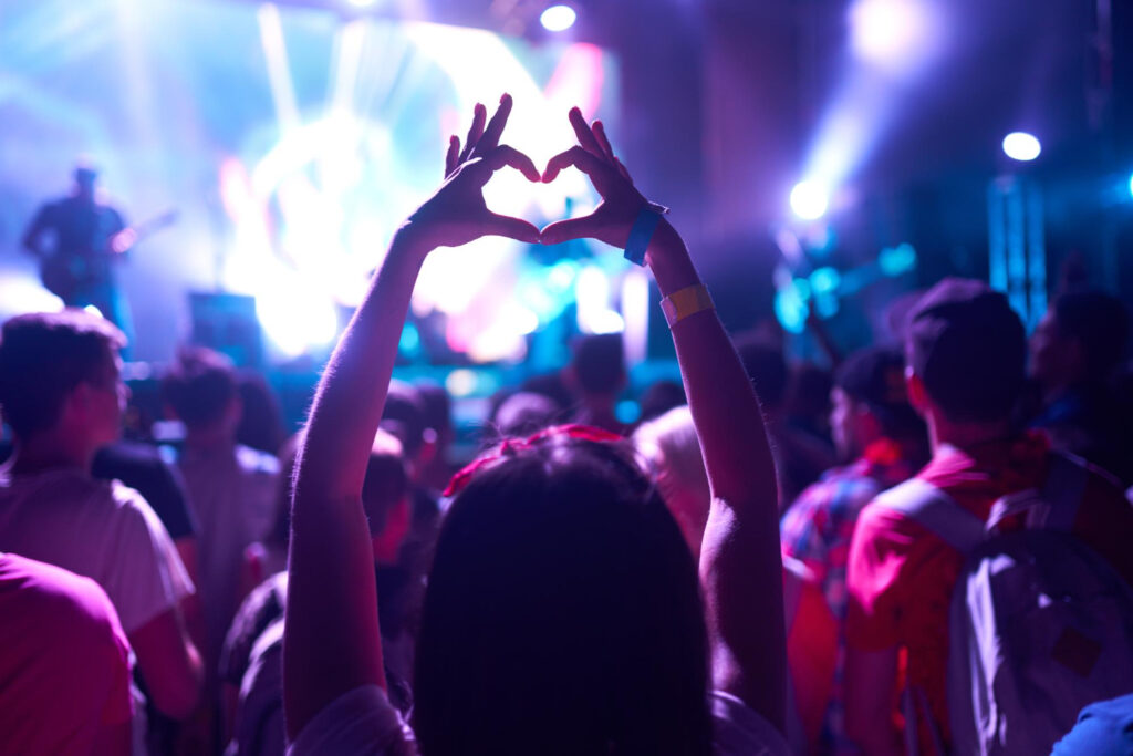 people taking photographs with smart phone during music festival fans enjoying rock concert